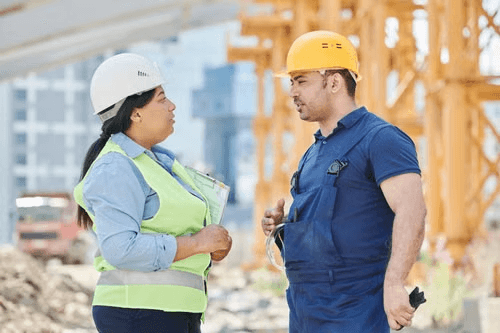 Two engineers discussing a project on site